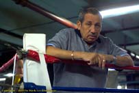 Weary trainer at boxing gym